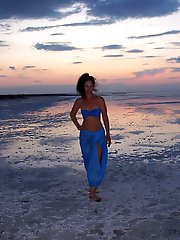 On sand seminude with light-color vase