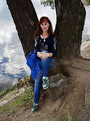 A beautiful mature woman is fondling her genital area